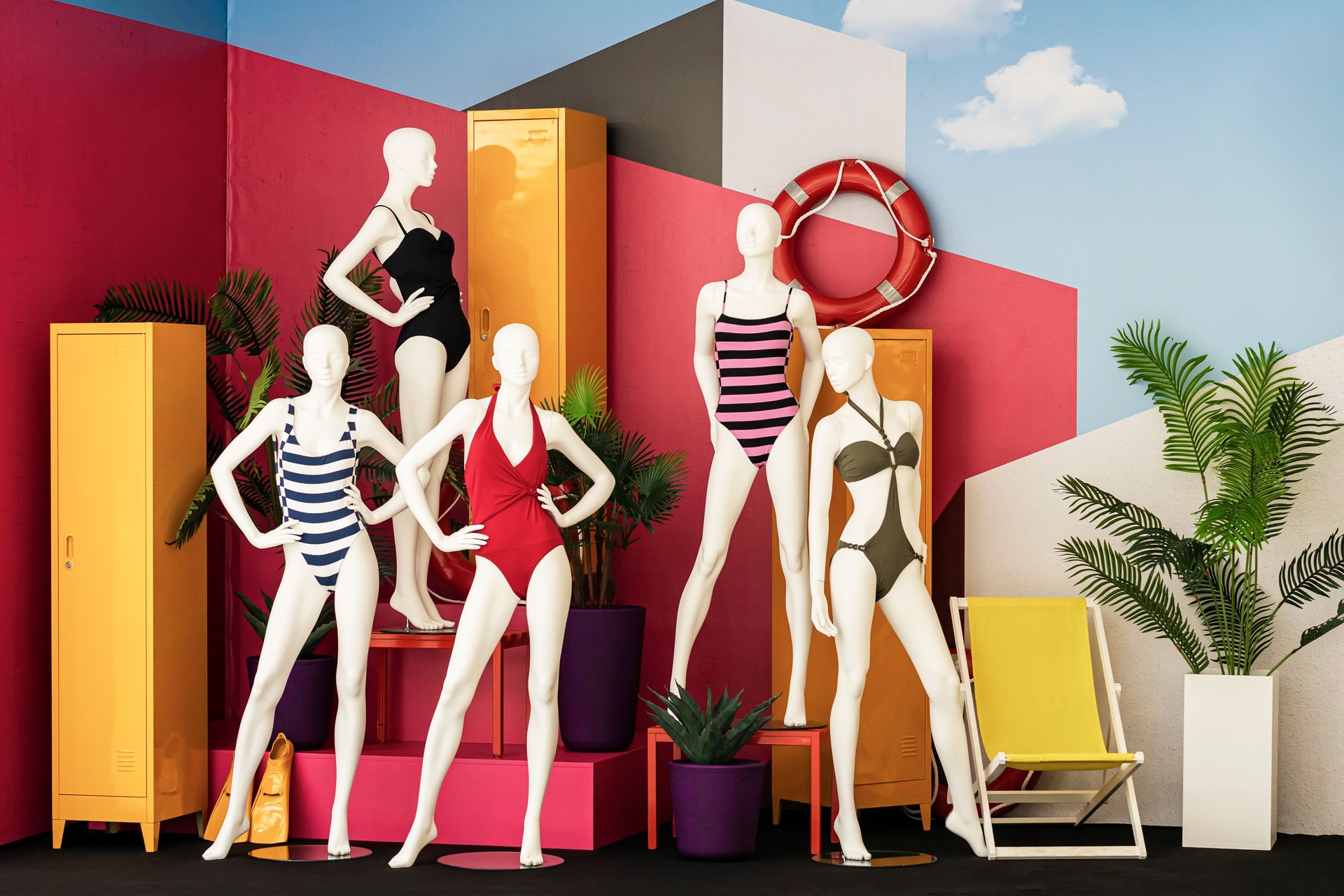 Female mannequins in colorful swimsuits in clothes shop. Summer sale. Shopping, leisure and vacation
